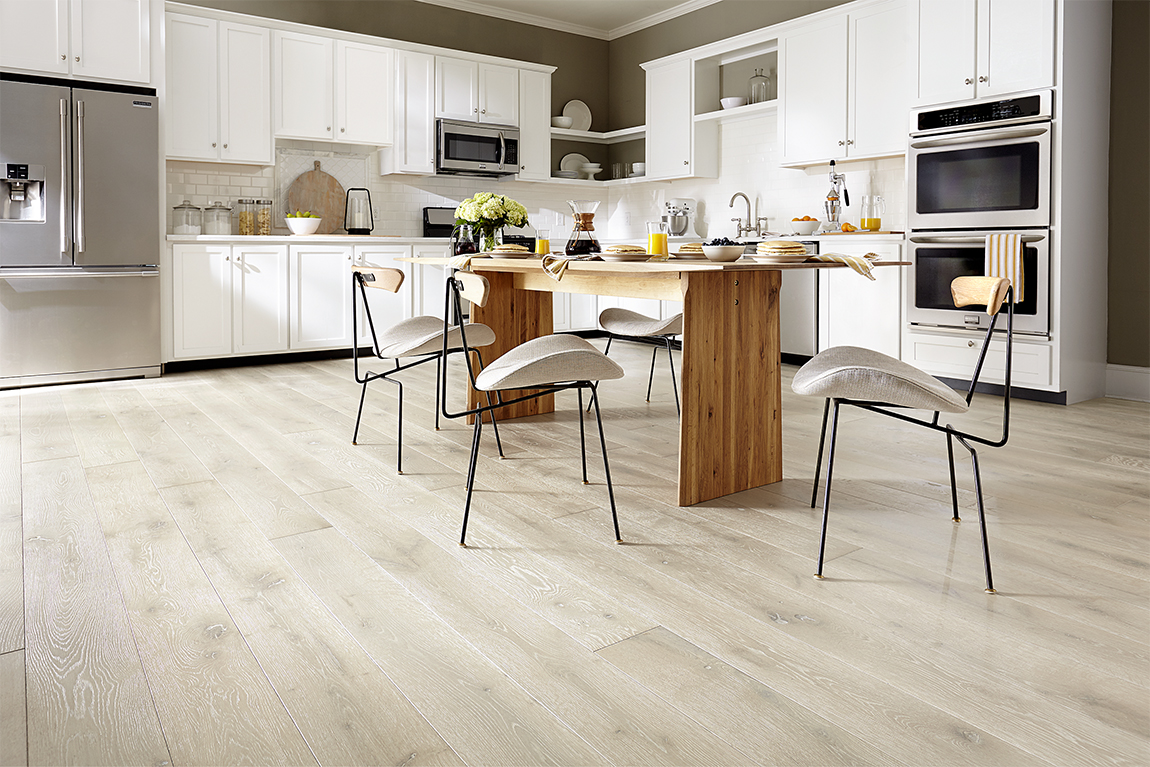 Floorcraft Hardwood in kitchen setting featuring modern appliances, table, and chairs.