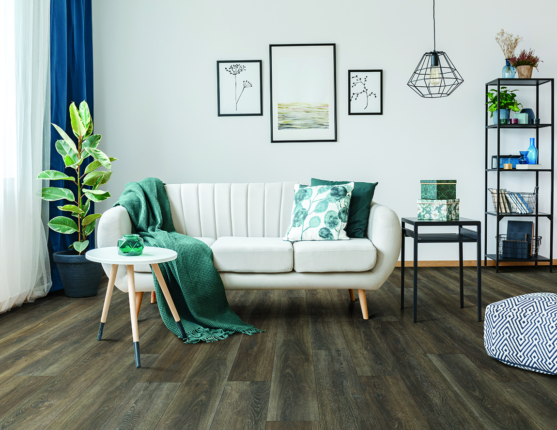 Luxury Vinyl Plank in living room setting with white coach, splashes of emerald blue decor items